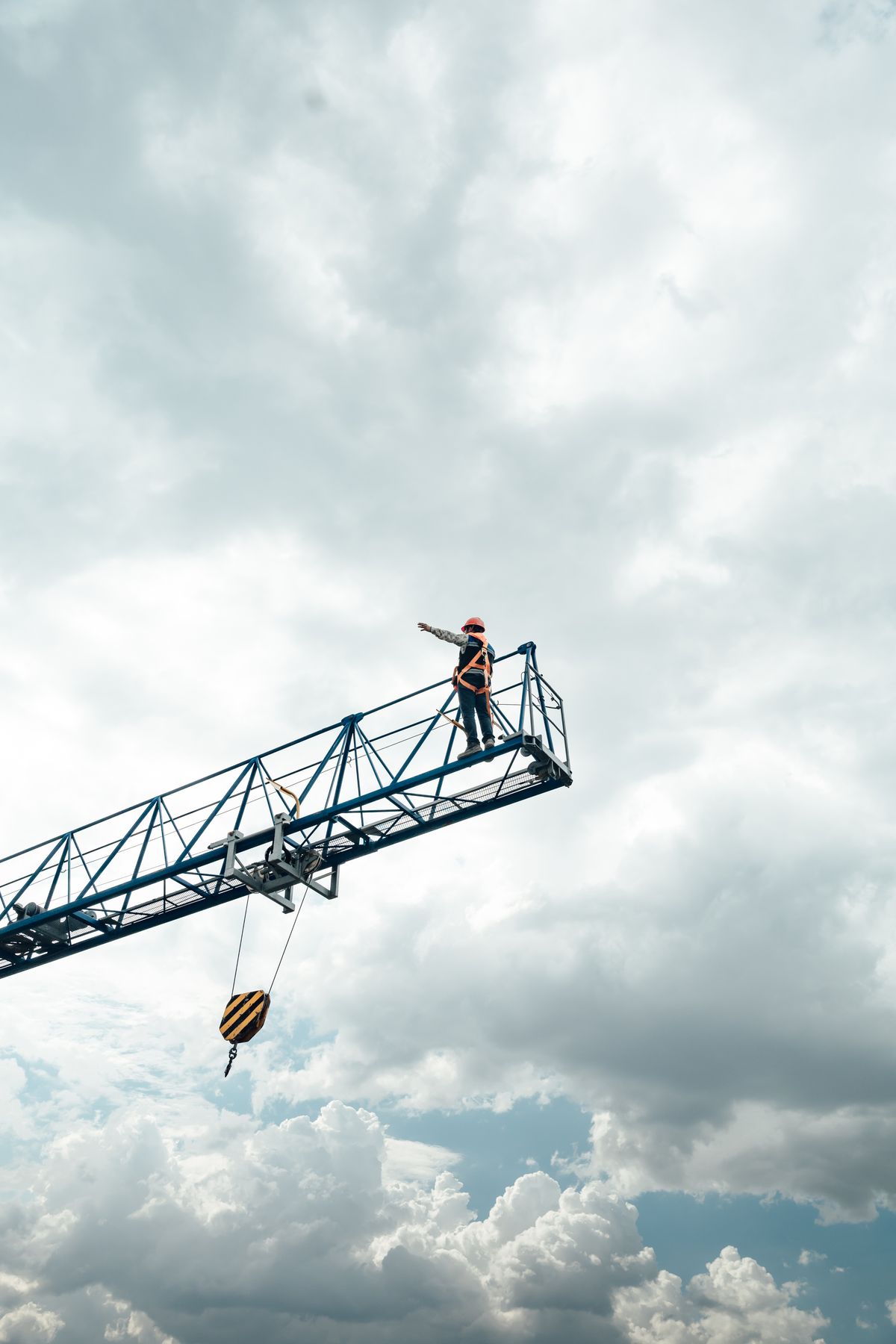 Construction worker inspecting a tower crane on a Tier-1 high-rise construction site in Australia