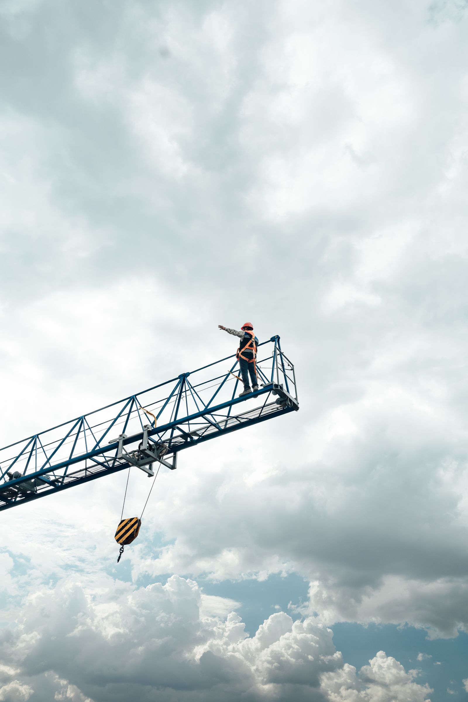 Technician working at height on an elevated work platform during a boom lift safety inspection