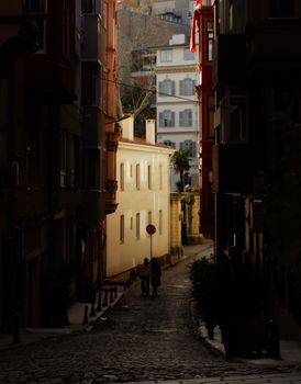 Explore a tranquil city street scene framed by charming buildings, evoking urban exploration and travel intrigue.