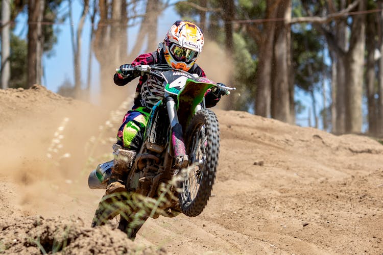 Photography Of Man Riding Motocross Dirt Bike During Daytiime