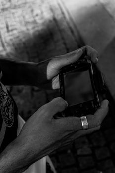 Black and white street photo capturing a person with handheld device in Porto, Portugal.