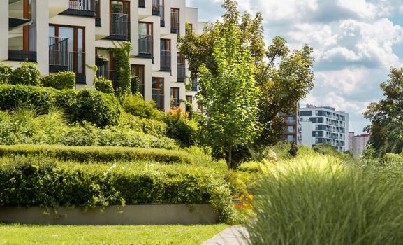 Elegant modern residential complex with lush gardens and urban landscape views.