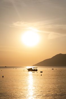 Silhouette of boat at sunset on São Paulo's coastline, Brazil. Beautiful golden hues.