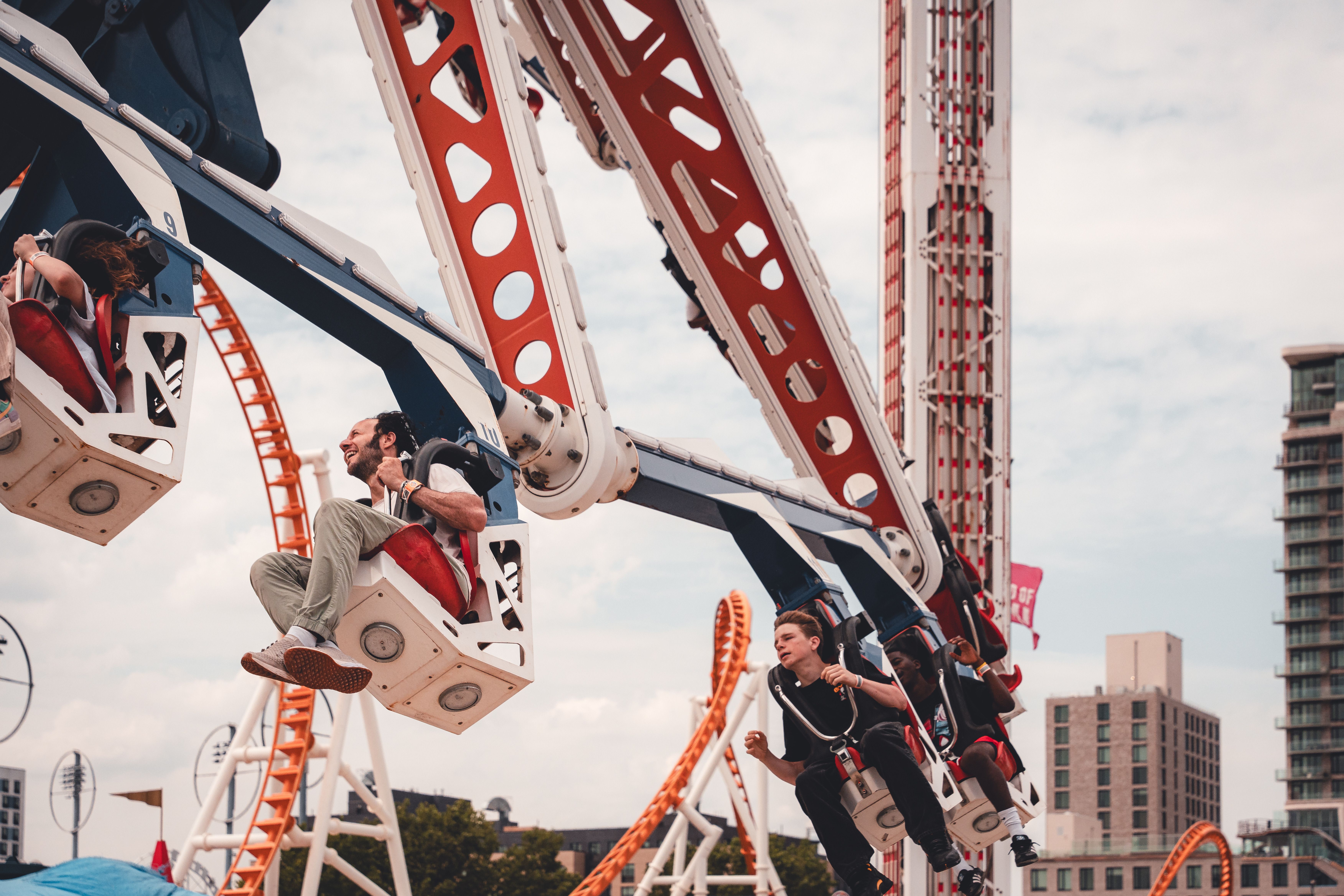 People riding on a roller coaster at an amusement park · Free Stock Photo