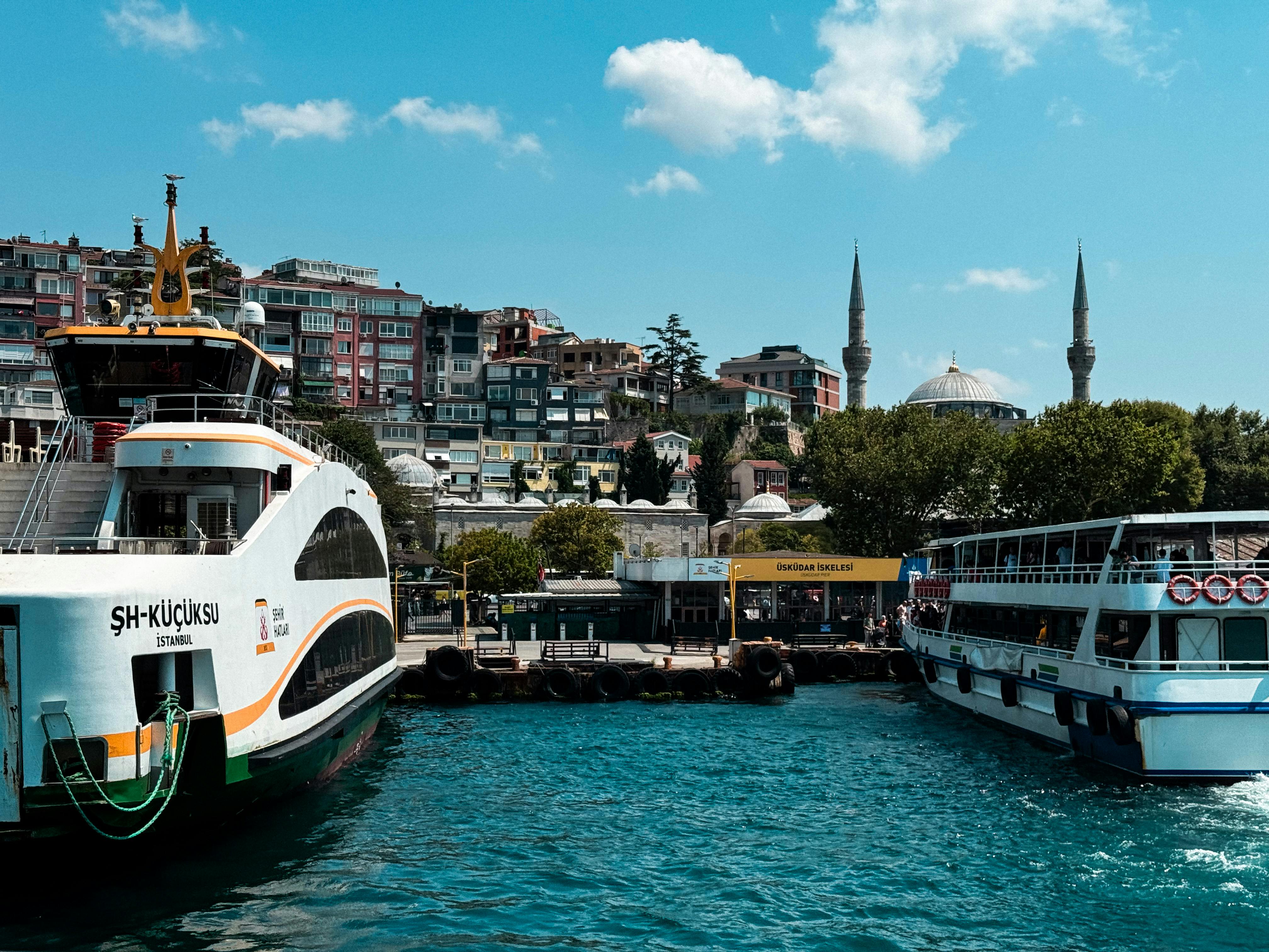 two ferries are docked in the water near a city