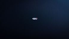 A solitary boat afloat in the calm, deep blue waters of Blackstone Lake, captured from above.