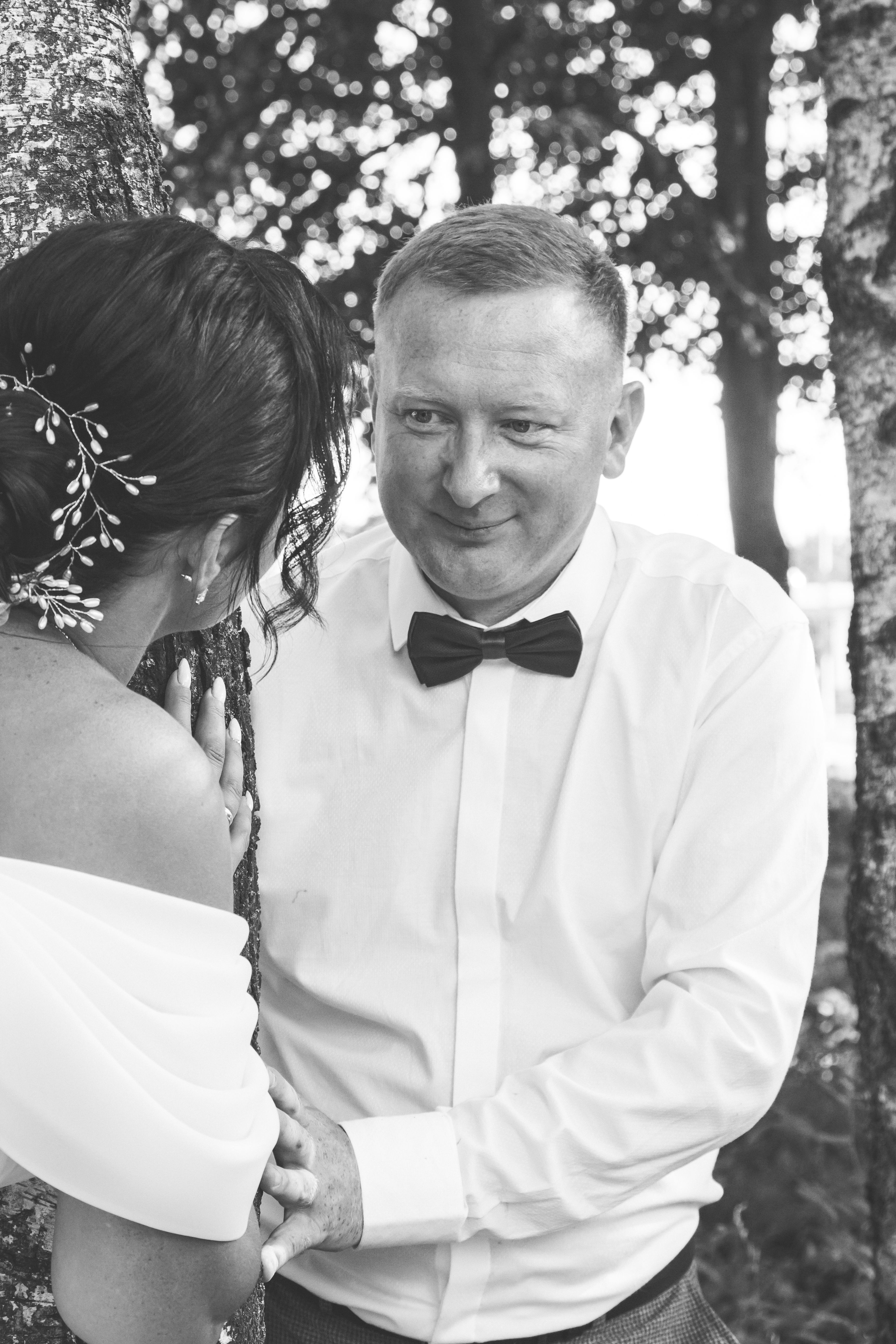 A bride and groom are standing in the woods · Free Stock Photo