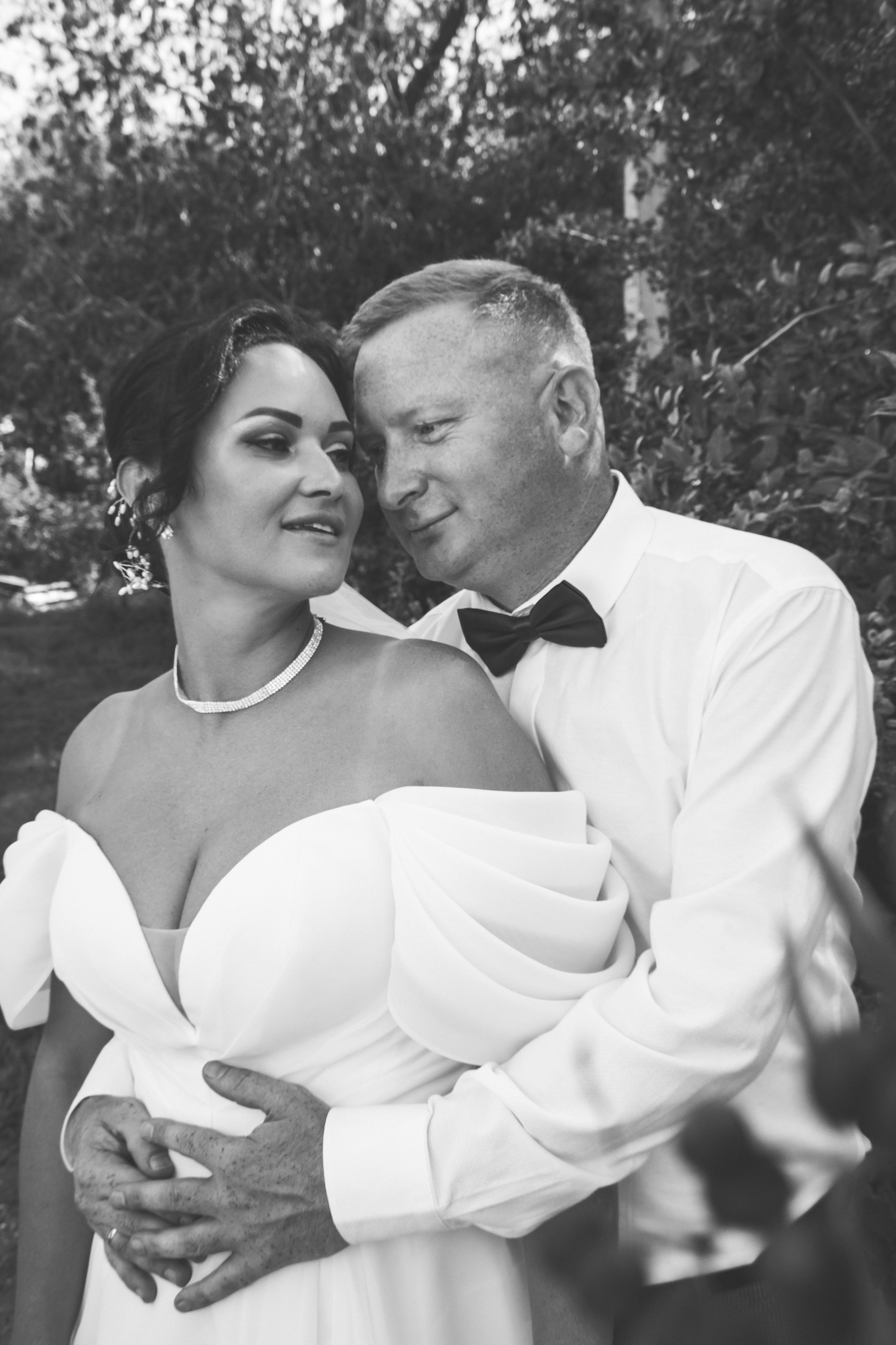 a black and white photo of a bride and groom