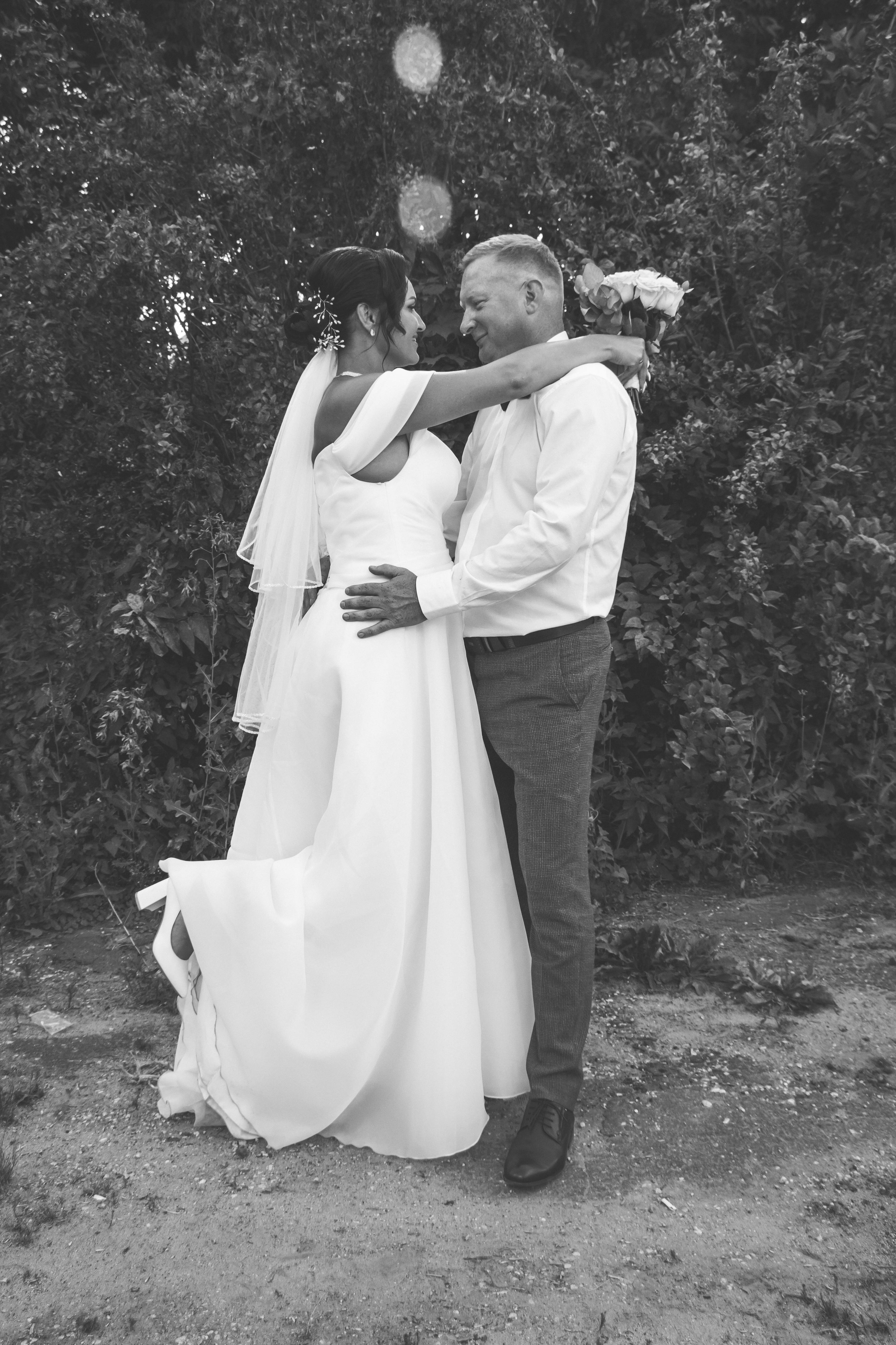 a black and white photo of a bride and groom