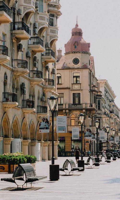 Free Charming urban square with historic buildings and vintage streetlamps, perfect for tourism. Stock Photo