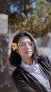 Lady Wearing Eyeglasses With Yellow Bell Flower On Hair