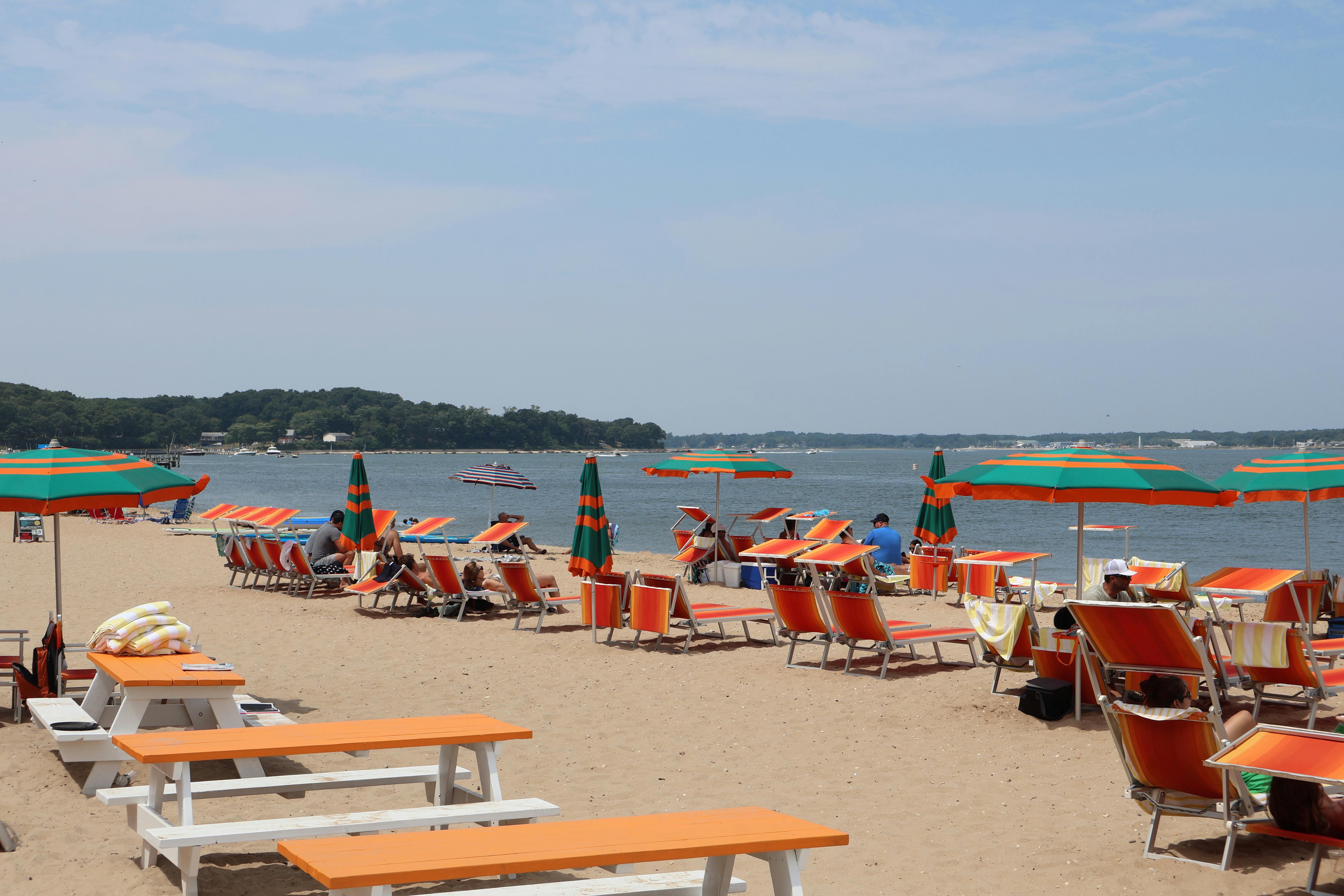 Colorful beach chairs and umbrellas on a sunny day at Shelter Island, NY.