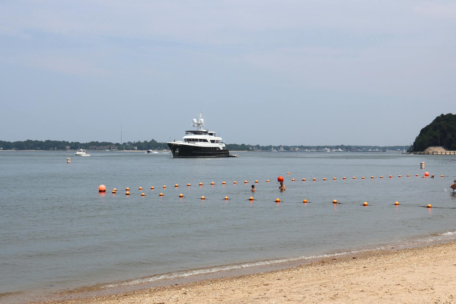 A serene view of a yacht anchored near Shelter Island beach in New York.