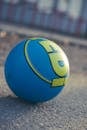 A blue and yellow ball on the ground