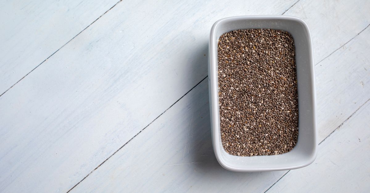 A close-up of chia seeds in a white bowl on a light wooden surface, showcasing a healthy food concept. - Evidence evidence guide for chia seed blood glucose randomized trial