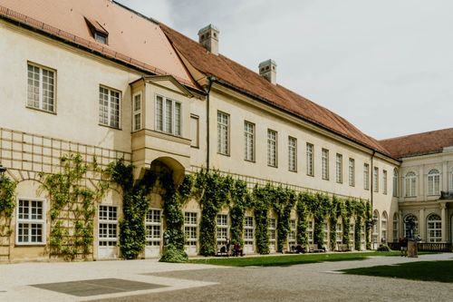 Free Sunlit Baroque architecture with ivy-covered walls in Munich, Germany. Stock Photo