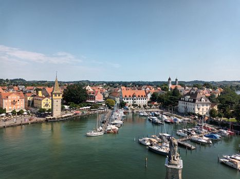 A picturesque aerial view of Lindau Harbor showcasing sailboats, historic architecture, and vibrant waterfront.