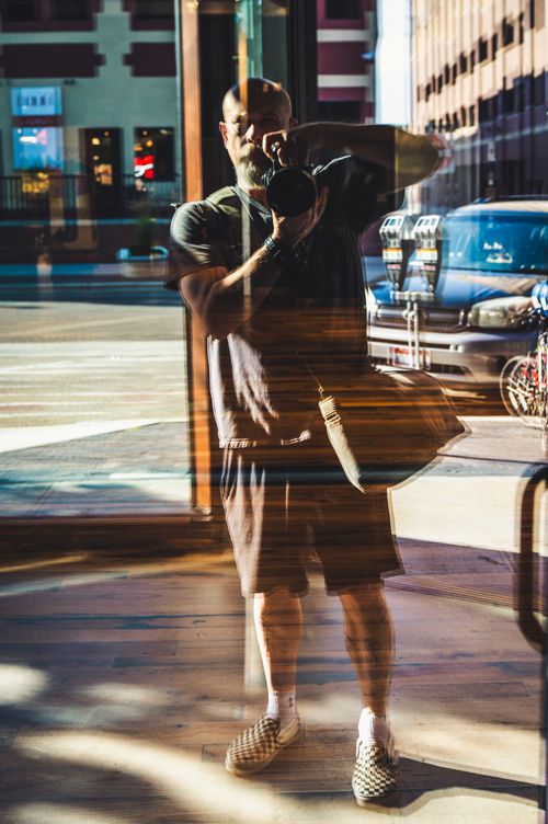 Free Artistic reflection of a man photographing a cityscape in downtown Boise, Idaho. Stock Photo