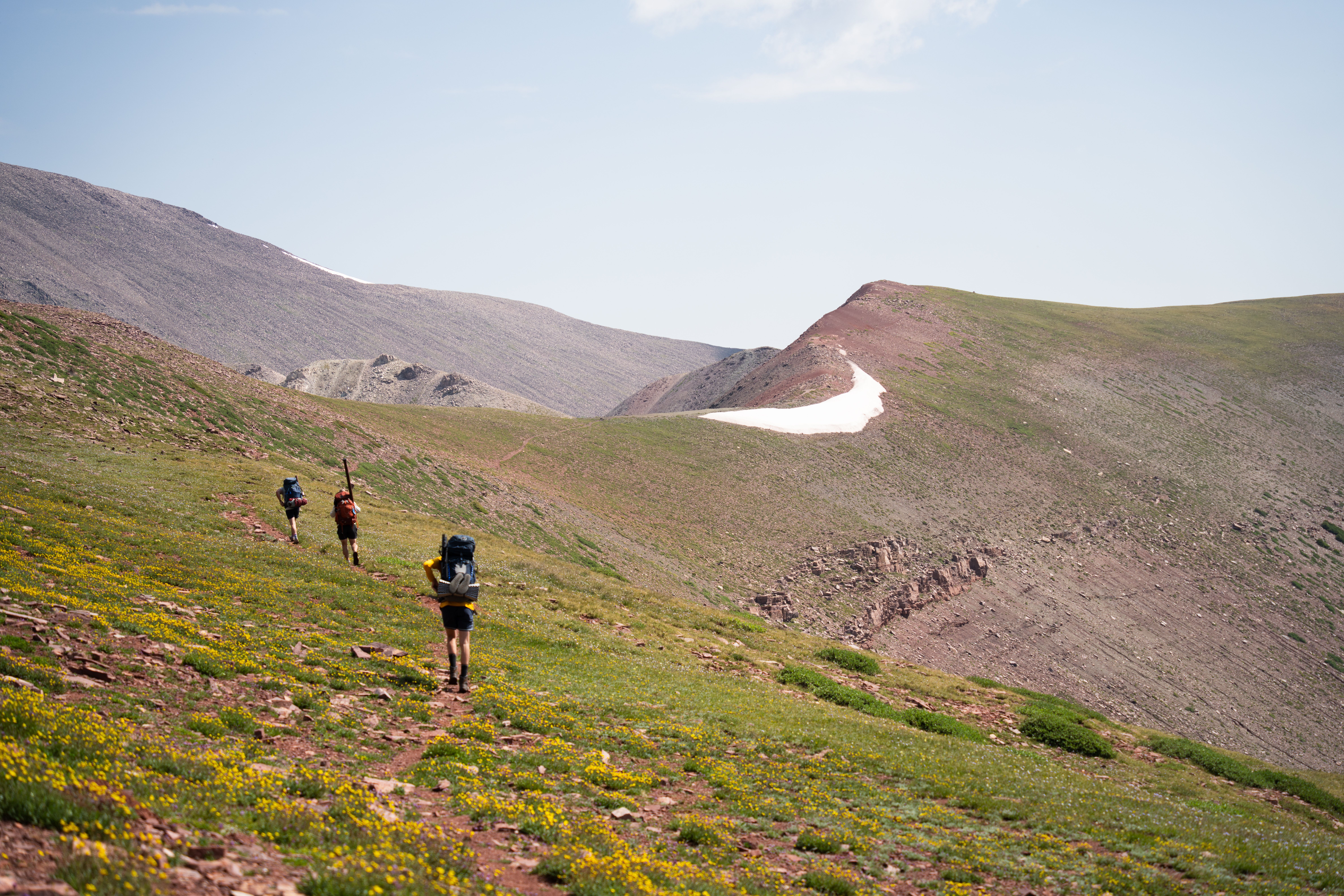 A group of people hiking up a mountain · Free Stock Photo