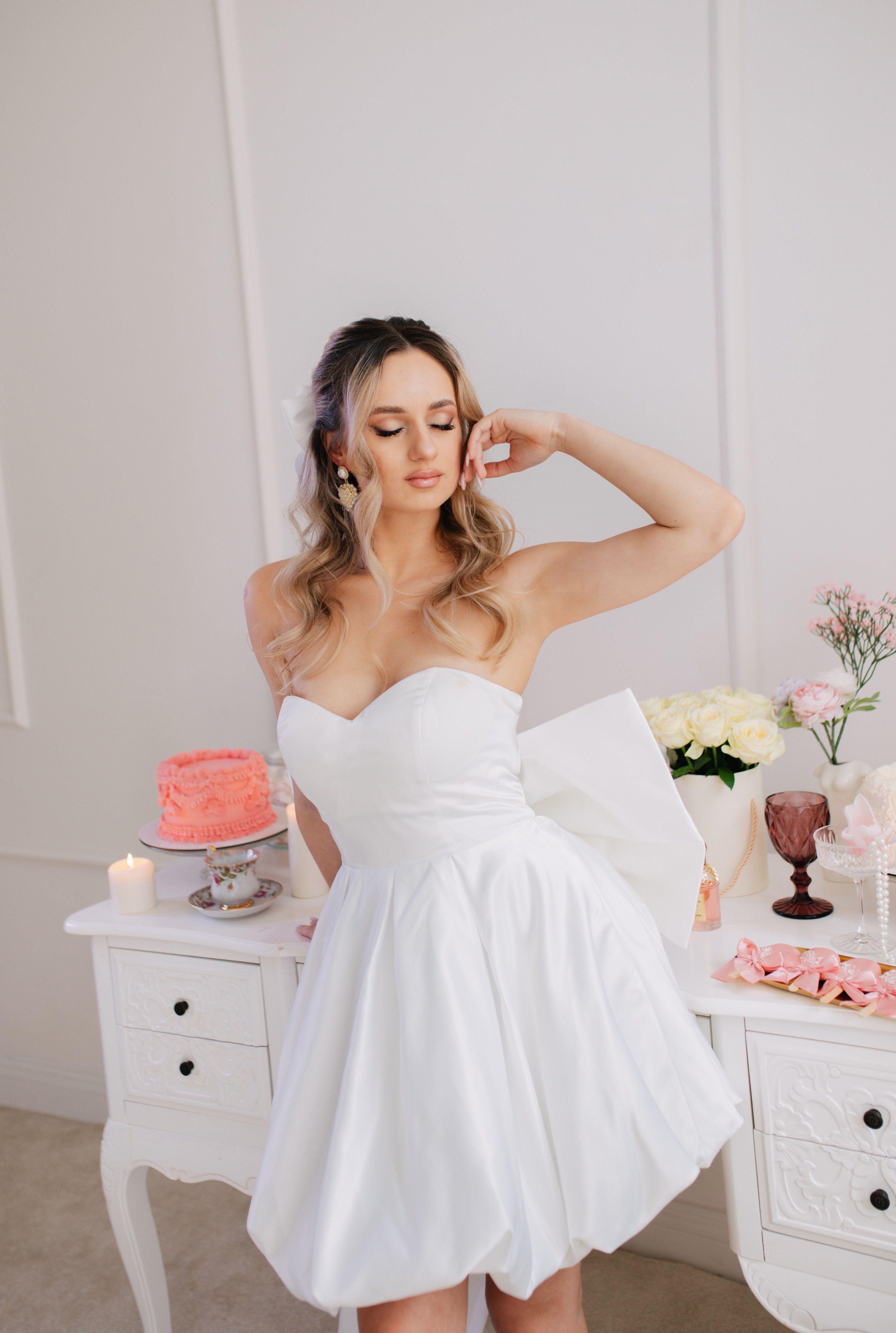 A woman in a white dress is posing for a photo · Free Stock Photo