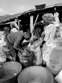 Vibrant African market with people selling goods in large sacks.