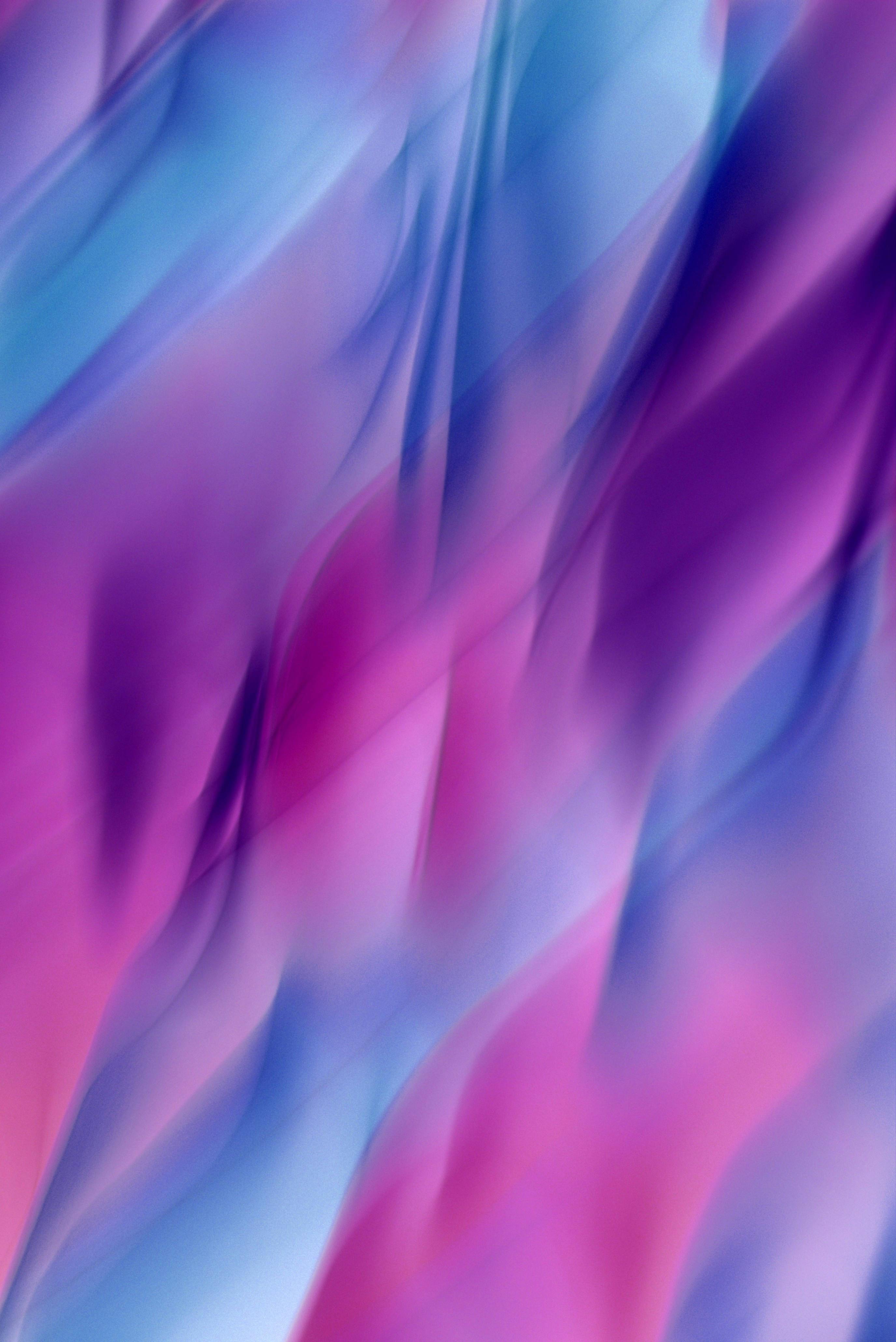 Dynamic abstract image with elegant waves of blue and pink colors.