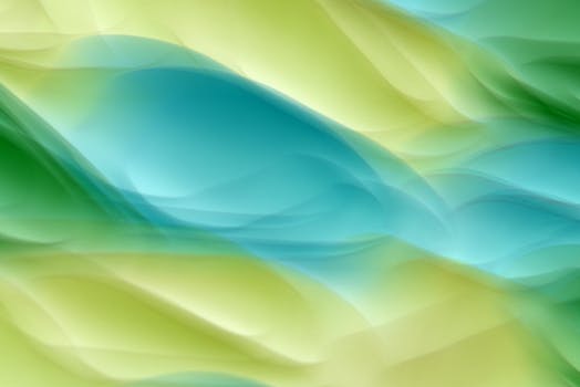 Vibrant abstract waves in green and blue hues creating a dynamic, artistic background.