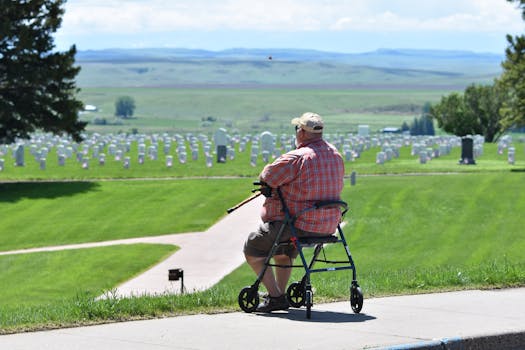 A veteran seated with walker, reflecting at a national cemetery in Garryowen, MT.