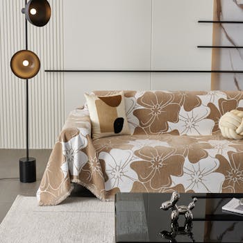 Stylish interior featuring a floral sofa cover and modern decor elements.
