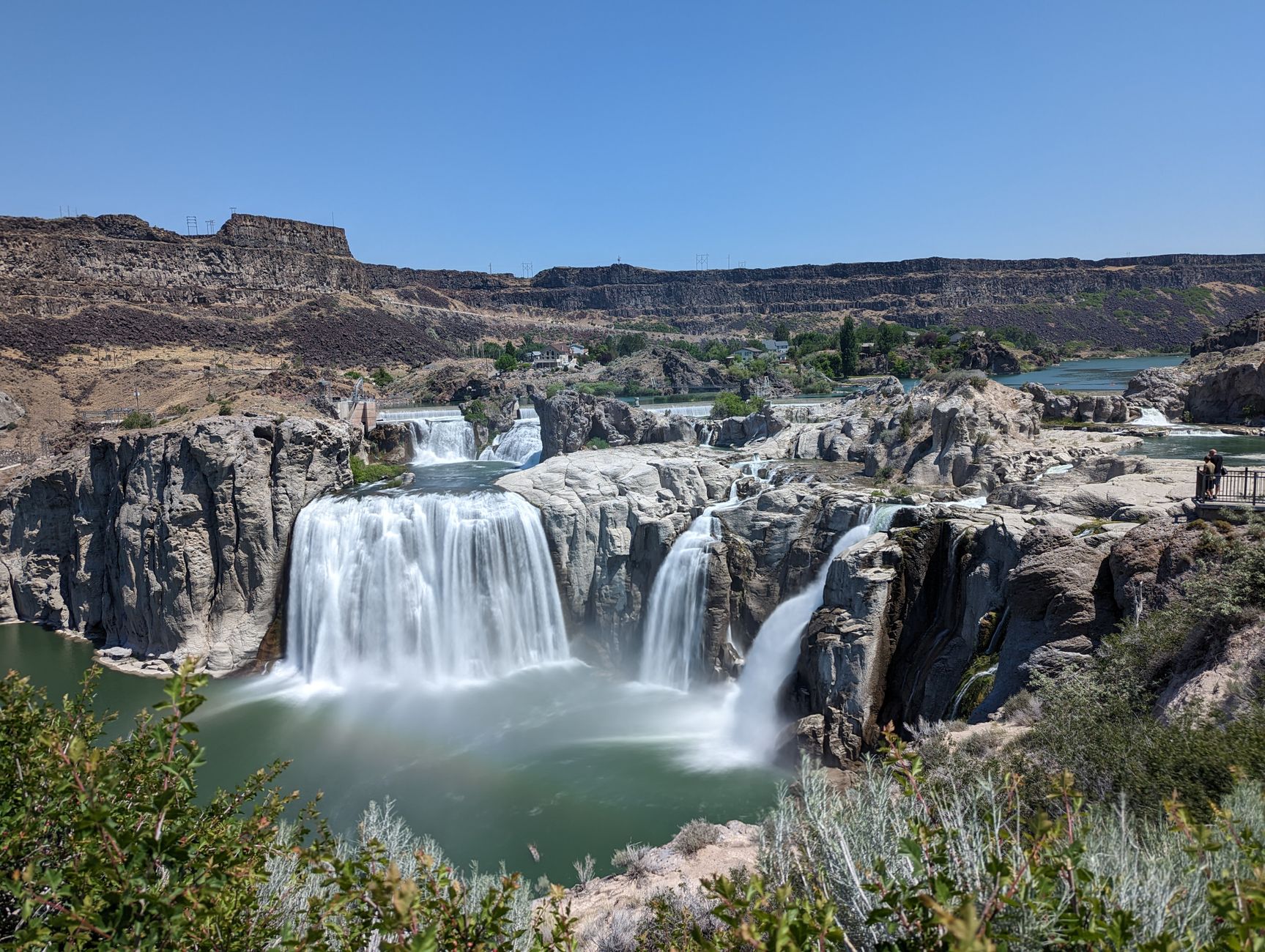 Marvel at the breathtaking Shoshone Falls cascading in full flow under a clear summer sky.