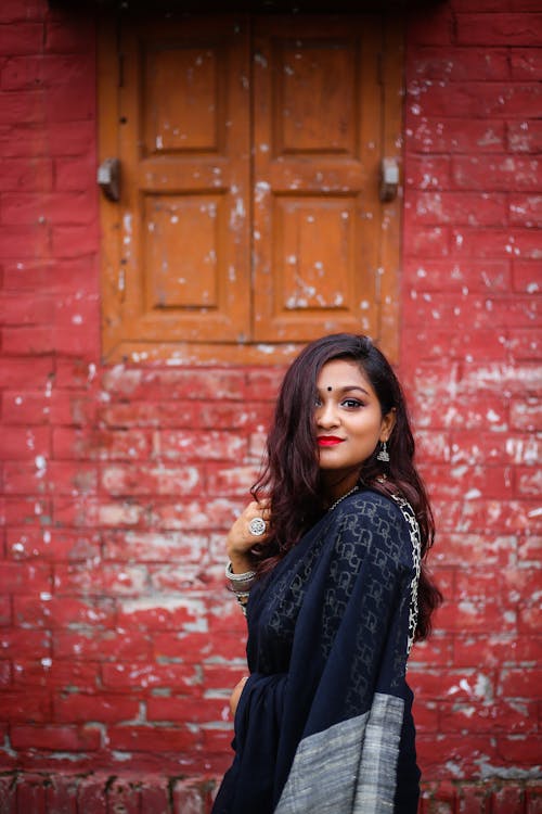 Free A Woman in Black Saree Smiling Stock Photo