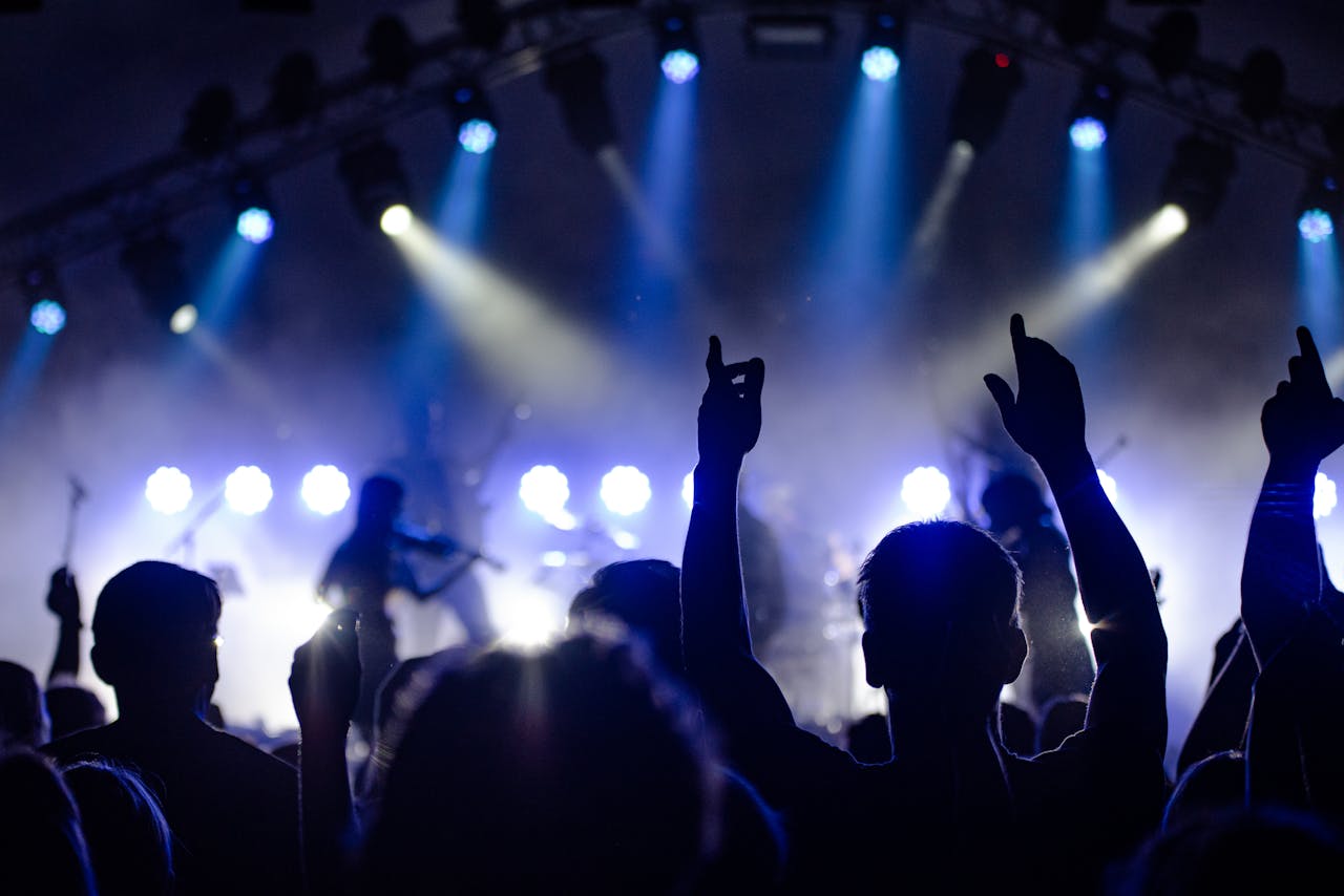 Live audience at a rock concert with hands in the air