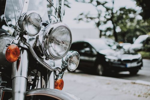 Free Headlights of motorbike with black car on asphalt road on background in city street Stock Photo
