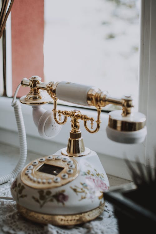 Retro telephone placed on plastic windowsill