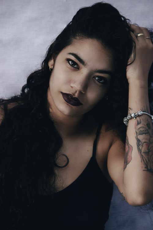 Free Elegant portrait of a woman with tattoo and dark makeup showing style and confidence. Stock Photo