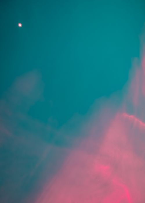 Free Surreal pink and teal sky with soft clouds resembling a dreamy atmosphere. Stock Photo