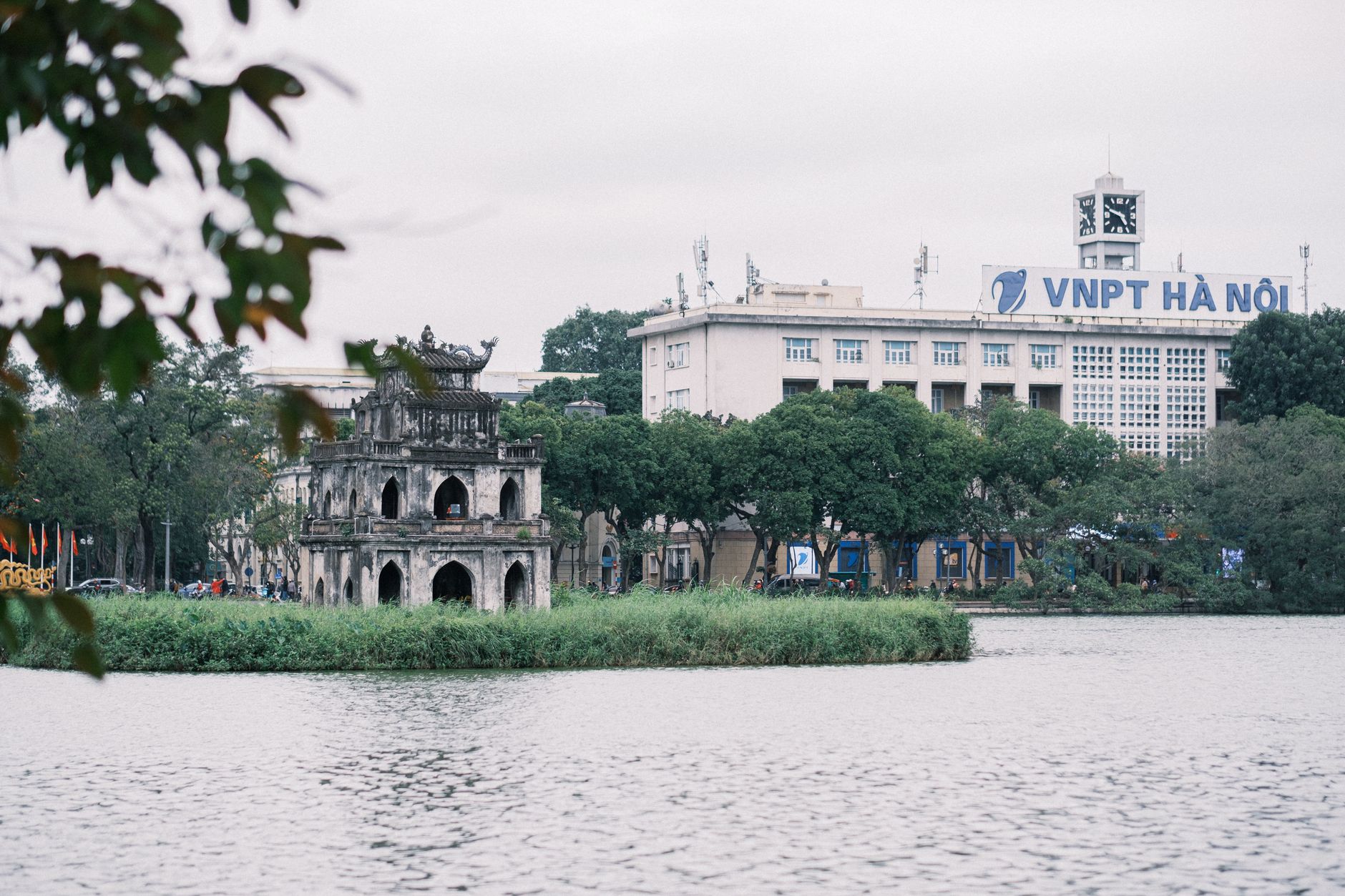 Scenic view of Hoàn Kiếm Lake with Turtle Tower and VNPT building in Hanoi, Vietnam.