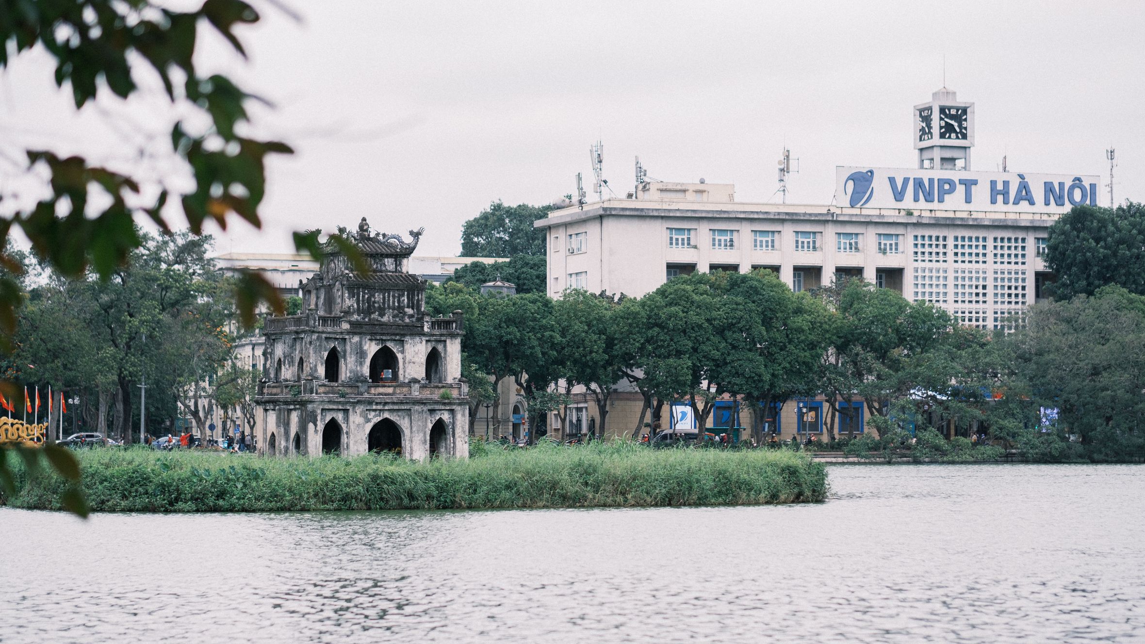 Scenic view of Hoàn Kiếm Lake with Turtle Tower and VNPT building in Hanoi, Vietnam.