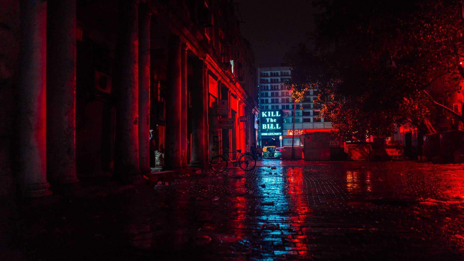 An atmospheric urban street scene at night with neon red and blue reflections and empty pavements.. pexels, atmospheric, urba