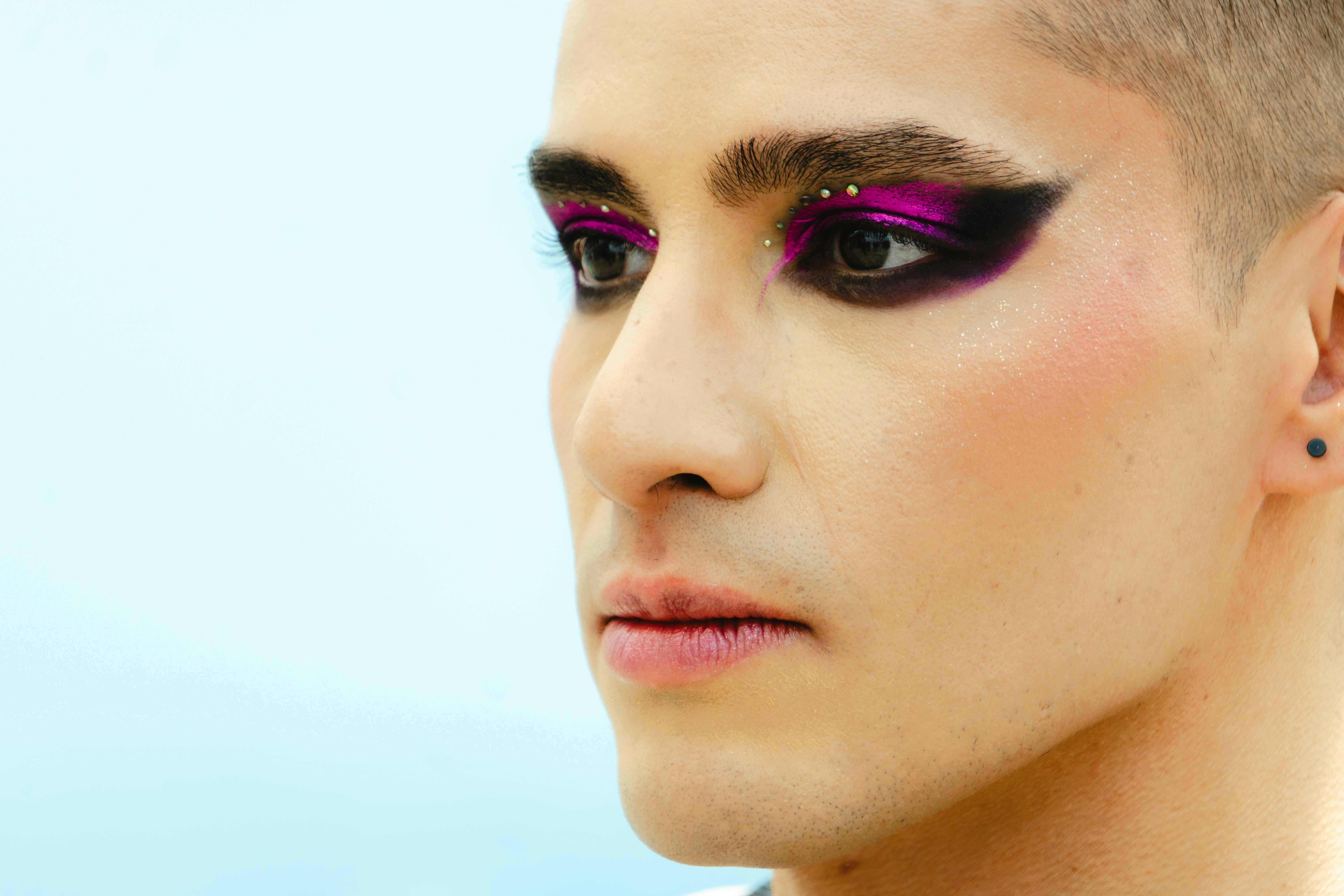 a man with purple and pink makeup