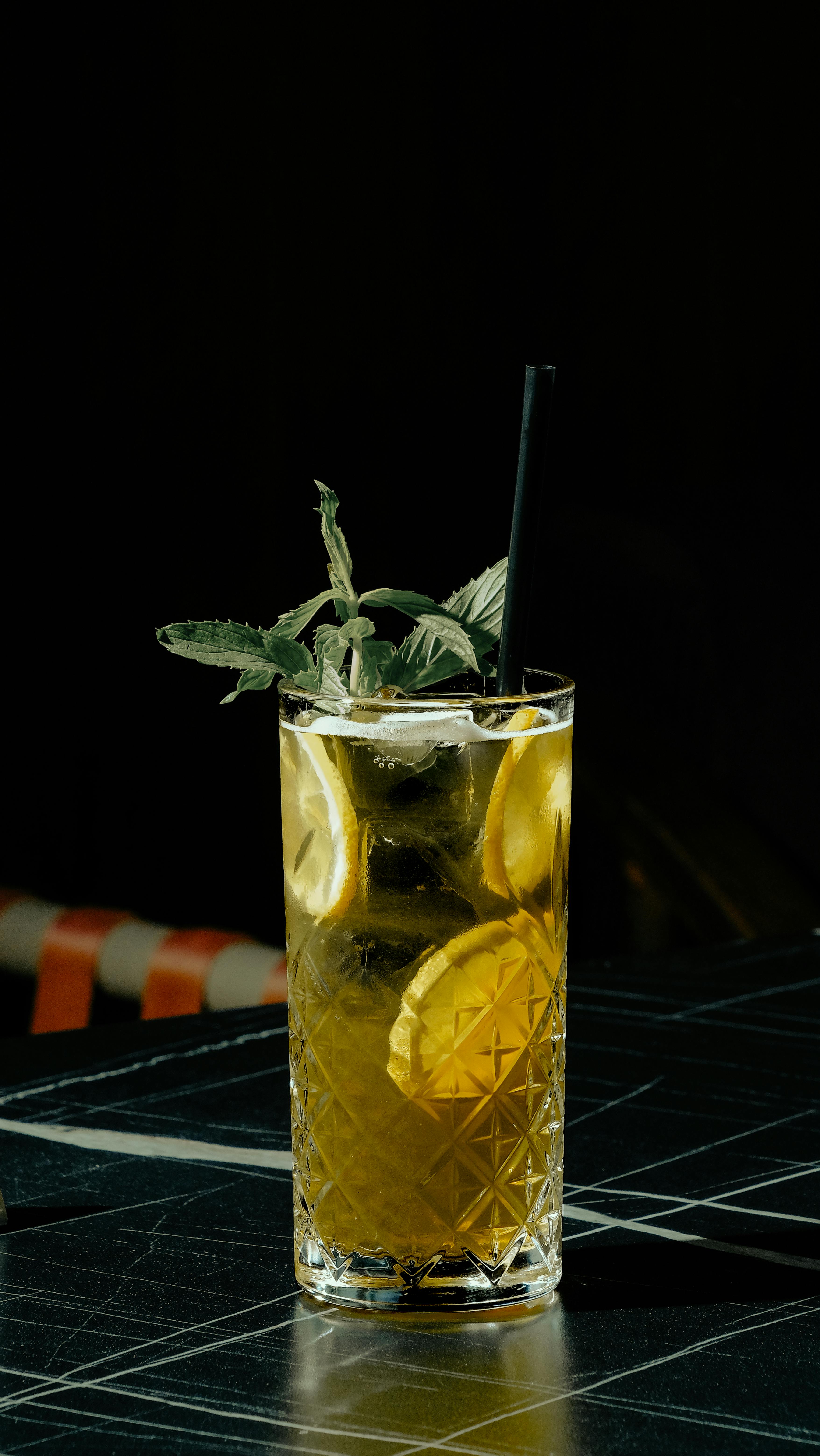 a glass of lemonade with mint leaves on top