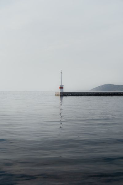A lighthouse in calm water — photo by Iulian Sandu on Pexels