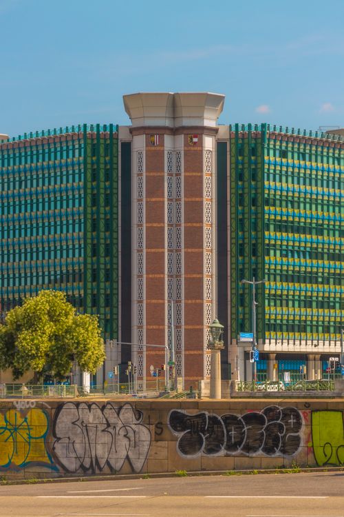 Free Contemporary urban building with patterned facade and graffiti in foreground. Stock Photo