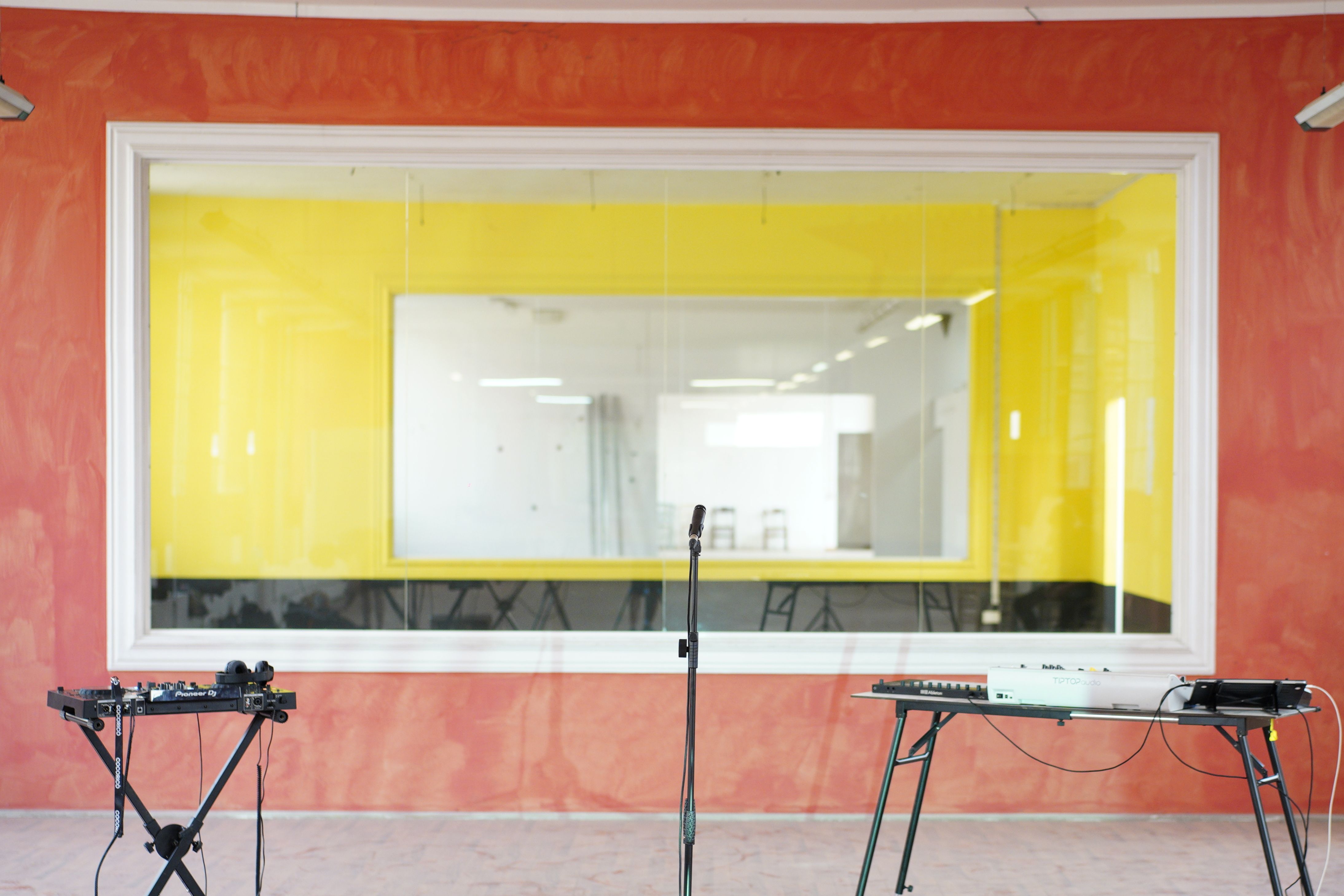 Contemporary DJ studio interior with equipment and bright colors perfect for music production themes.