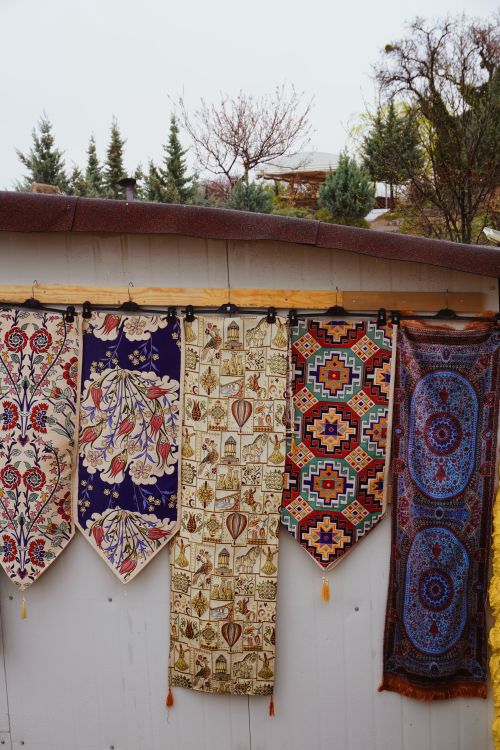Filded Hanging Rug A row of colorful rugs hanging on a wall · Free Stock Photo