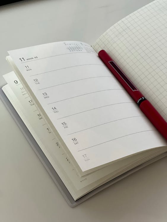 Free A pen is sitting on top of a notebook Stock Photo