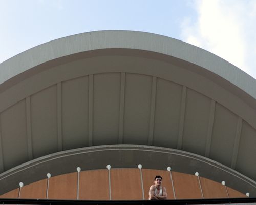Free A modern architectural structure in Berlin featuring a domed roof and a person visible below, under a clear sky. Stock Photo