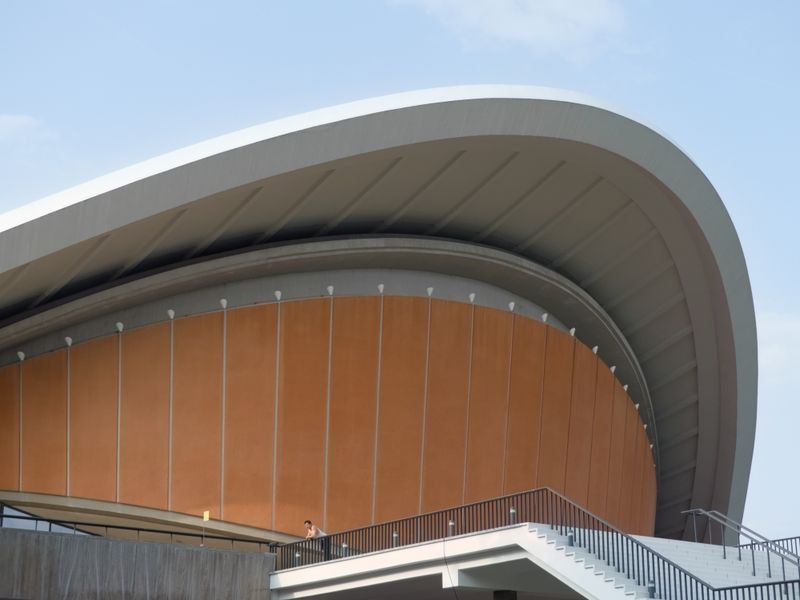 Sweeping curved roof of a modern venue