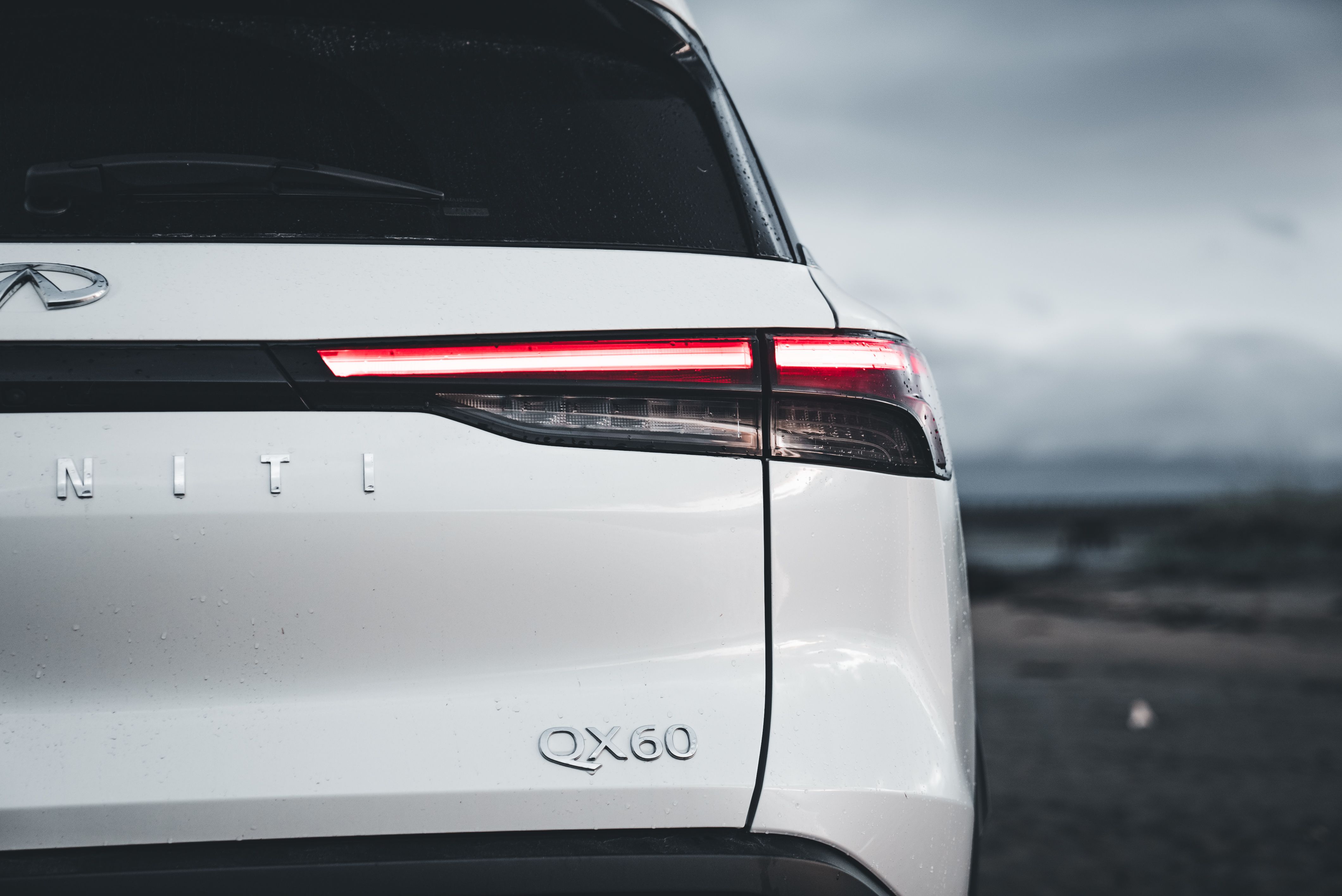 Luxury SUV parked outdoors under overcast sky.