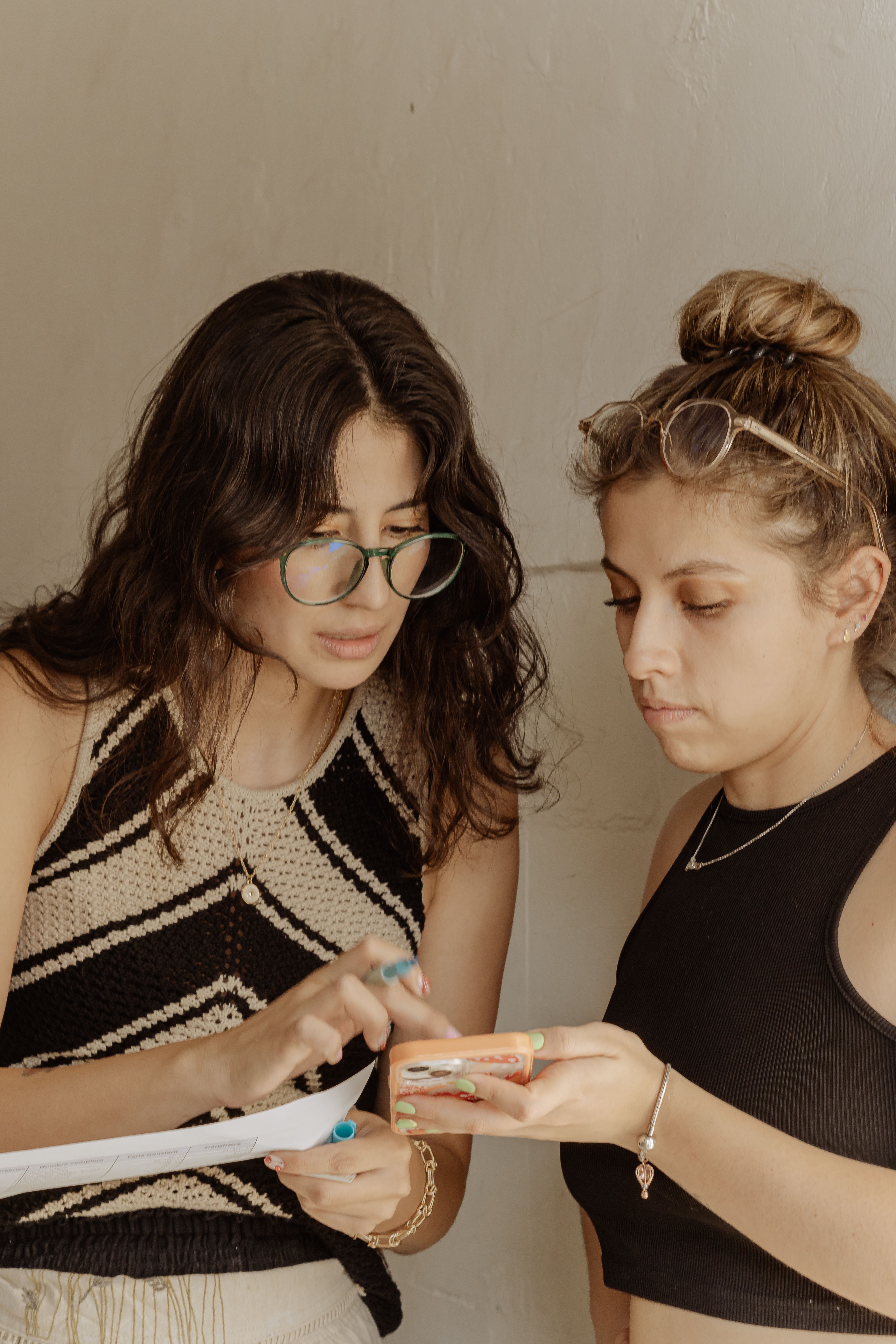 A Bright Futures caseworker reviewing a tutoring plan with a student and her mother at a community center table